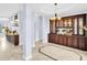 Elegant Living Room featuring chandelier, marble tile flooring, and decorative cabinet at 1424 Ridge Shore Dr, Tarpon Springs, FL 34689
