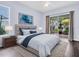 A beautifully staged main bedroom boasts a king bed and a sliding door to a patio at 1424 Ridge Shore Dr, Tarpon Springs, FL 34689