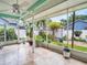 View of a screened-in patio with potted plants and a glimpse of the fenced-in backyard at 1424 Ridge Shore Dr, Tarpon Springs, FL 34689
