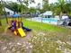 Colorful community playground featuring slides and climbing structures on a sunny day at 1424 Ridge Shore Dr, Tarpon Springs, FL 34689