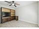 Neutral bedroom features wood built-ins, tile flooring, and a ceiling fan at 15014 Winterwind Dr, Tampa, FL 33624