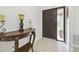 Inviting entrance foyer with a decorative wood console table and a stylish front door with glass panel at 15014 Winterwind Dr, Tampa, FL 33624