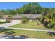 Well maintained single Gathering home with tropical landscaping and stone accents on the garage and support columns at 15014 Winterwind Dr, Tampa, FL 33624