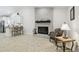 Open-concept living room with fireplace and a view to the modern kitchen at 15014 Winterwind Dr, Tampa, FL 33624