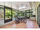 Enclosed patio with seating area overlooking a lush garden at 15014 Winterwind Dr, Tampa, FL 33624