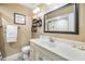Well-lit bathroom featuring a large mirror, tile floors, and a spacious vanity at 16214 W Course Dr, Tampa, FL 33624