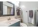 Bathroom features a blue vanity, dark framed mirror, and neutral wall color at 16214 W Course Dr, Tampa, FL 33624