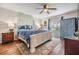 This main bedroom features wood flooring, a ceiling fan and bright natural light at 16214 W Course Dr, Tampa, FL 33624
