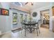 Bright dining area features tile flooring, and double doors leading to the pool at 16214 W Course Dr, Tampa, FL 33624