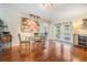 Bright dining room with hardwood floors, modern art, and french doors leading to the outside at 16214 W Course Dr, Tampa, FL 33624