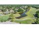 Community golf course featuring a tranquil pond surrounded by lush greenery and mature trees at 16214 W Course Dr, Tampa, FL 33624