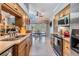 Open kitchen with plenty of counter space and a pass-through window to the living room at 16214 W Course Dr, Tampa, FL 33624