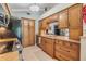 Well-lit kitchen with stone countertops and light wood cabinets at 16214 W Course Dr, Tampa, FL 33624