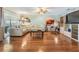 Spacious living room with hardwood floors, a ceiling fan, and a plush sectional sofa at 16214 W Course Dr, Tampa, FL 33624