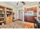 Inviting home office with custom built in shelving, hardwood floors and wine bar area at 16214 W Course Dr, Tampa, FL 33624