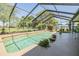 Screened-in pool surrounded by lush landscaping at 16214 W Course Dr, Tampa, FL 33624