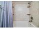 Shower with shower and tile surround with decorative accents at 16214 W Course Dr, Tampa, FL 33624