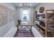 Stylish home office featuring a wood desk, large window, and open shelving at 16305 Pebble Ridge Dr, Lakewood Ranch, FL 34211
