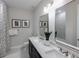 Elegant bathroom featuring dual sinks, black cabinets, and modern fixtures for a sleek and stylish design at 16411 Sapphire Point Dr, Lakewood Ranch, FL 34211