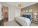 Comfortable bedroom with a large bed, stylish nightstands, and a unique ceiling fan creating a relaxing atmosphere at 16411 Sapphire Point Dr, Lakewood Ranch, FL 34211