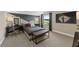 Contemporary bedroom featuring a patterned accent wall, sleek furniture, and a scenic window view at 16411 Sapphire Point Dr, Lakewood Ranch, FL 34211