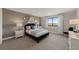 Bright bedroom featuring a black bed frame, accent stars, and sheer curtains for a modern, airy feel at 16411 Sapphire Point Dr, Lakewood Ranch, FL 34211