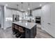 Modern kitchen with stainless steel appliances, white cabinets, quartz countertops, and a central island with bar seating at 16411 Sapphire Point Dr, Lakewood Ranch, FL 34211