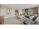 Inviting living room featuring a comfortable sectional sofa and modern decor with a glimpse into additional rooms at 16411 Sapphire Point Dr, Lakewood Ranch, FL 34211