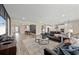 Spacious open-concept living area with a large sofa, modern furnishings, and views to the kitchen and dining areas at 16411 Sapphire Point Dr, Lakewood Ranch, FL 34211