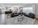 Open-concept living room with a kitchen, dining area, sliding doors to an outdoor area, and modern furnishings at 16411 Sapphire Point Dr, Lakewood Ranch, FL 34211