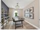 Modern office with a geometric chandelier, sleek desk, and large window at 16411 Sapphire Point Dr, Lakewood Ranch, FL 34211