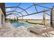 Private screened pool and spa with sun loungers overlooking the serene waterfront at 16411 Sapphire Point Dr, Lakewood Ranch, FL 34211