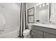 Clean bathroom featuring modern fixtures, vanity, and shower with a decorative black and white curtain at 16415 Sapphire Point Dr, Lakewood Ranch, FL 34211
