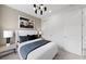 Comfortable bedroom with a stylish white bed, modern lighting, and closet, designed for relaxation at 16415 Sapphire Point Dr, Lakewood Ranch, FL 34211