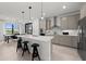 Modern kitchen with a large island, stainless steel appliances, and stylish pendant lighting at 16415 Sapphire Point Dr, Lakewood Ranch, FL 34211