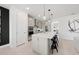 Modern kitchen with a large island, stainless steel appliances, and stylish pendant lighting at 16415 Sapphire Point Dr, Lakewood Ranch, FL 34211