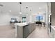 Modern kitchen with a large island, stainless steel appliances, and open-concept living area at 16415 Sapphire Point Dr, Lakewood Ranch, FL 34211