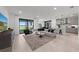 Bright, open living room with modern decor, tile floors, and sliding glass doors to outdoor living space at 16415 Sapphire Point Dr, Lakewood Ranch, FL 34211