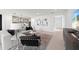 Open-concept living area with modern furnishings, adjacent kitchen, and bright natural light at 16415 Sapphire Point Dr, Lakewood Ranch, FL 34211