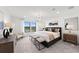 Bright main bedroom featuring a decorative chandelier, neutral colors, with a view to the water at 16415 Sapphire Point Dr, Lakewood Ranch, FL 34211