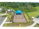 Aerial view of a fenced playground featuring swings, slides, and a blue sunshade at 16415 Sapphire Point Dr, Lakewood Ranch, FL 34211