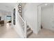 Modern staircase with white railings and carpeting, leading to the upper level at 16415 Sapphire Point Dr, Lakewood Ranch, FL 34211