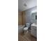 Functional bathroom with shower-tub, vanity, tile flooring, and neutral wall paint at 1708 E Genesee St, Tampa, FL 33610