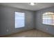 Cozy bedroom with natural light, tiled flooring, neutral paint and closet space at 1708 E Genesee St, Tampa, FL 33610