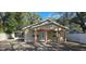 Charming single-story home with inviting front porch and well-maintained yard and a screened porch to the left at 1708 E Genesee St, Tampa, FL 33610