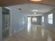 Spacious living room featuring tiled flooring, neutral paint, and natural light throughout at 1708 E Genesee St, Tampa, FL 33610