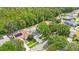 Aerial view of a property with a pool in a well-treed residential neighborhood at 18520 Ambly Ln, Tampa, FL 33647