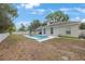 Private backyard featuring a sparkling pool, lush lawn, and a charming white fence, ideal for outdoor enjoyment at 18520 Ambly Ln, Tampa, FL 33647