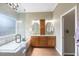Modern bathroom features a double sink vanity, glass shower, and soaking tub at 18520 Ambly Ln, Tampa, FL 33647