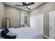 Lovely bedroom featuring wood-look floors, ceiling fan, closet, and lots of natural light at 18520 Ambly Ln, Tampa, FL 33647